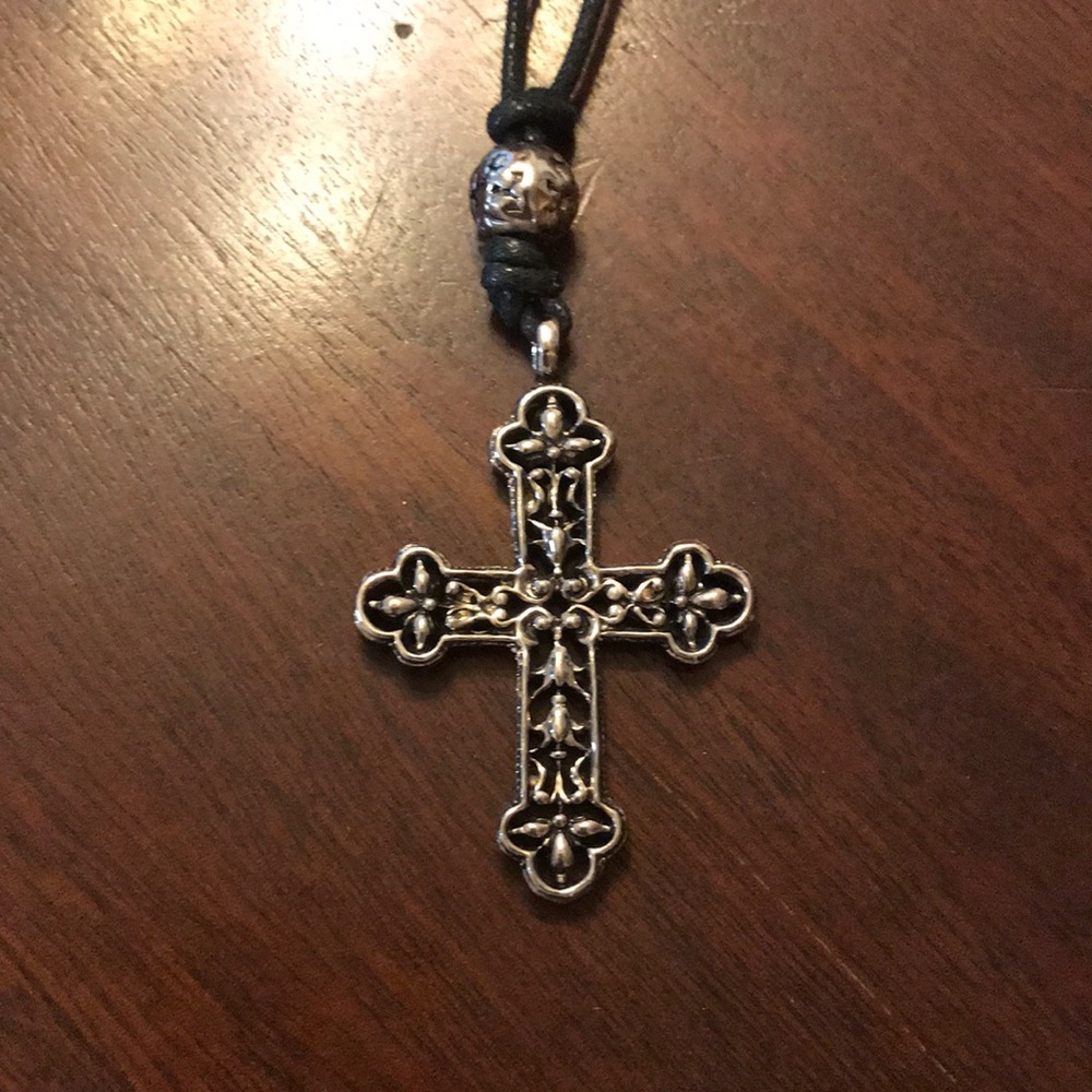 Silvertone filigree cross black leatherette cord